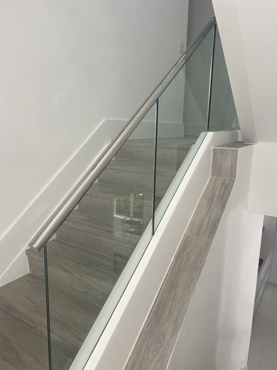 Glass stair railing installation in Florida by Safe Railing