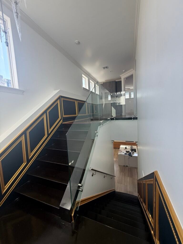 Glass stair railing with stainless handrail in a luxury South Florida home