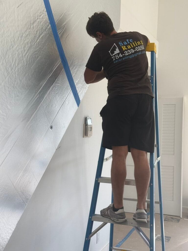 Safe Railing installer fitting a glass stair railing in Boca Raton