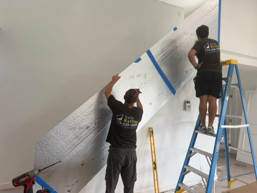 Safe Railing installers measuring and templating a glass stair railing on site
