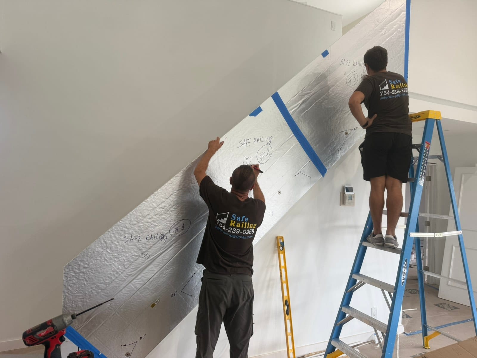 Safe Railing installers measuring and templating a railing on site before fabrication